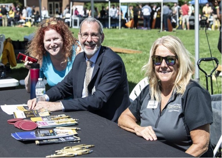 Dean of the College of Science, Ronald Friedman surrounded by fellow colleagues at the College of Science booth.